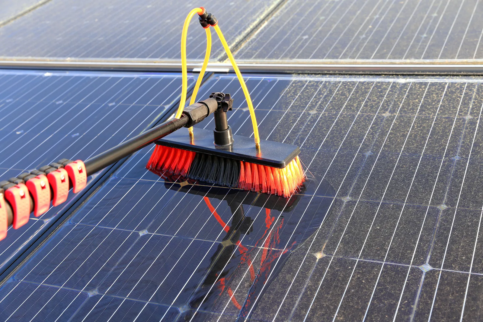 Specialized brush cleaning dust from residential solar panels